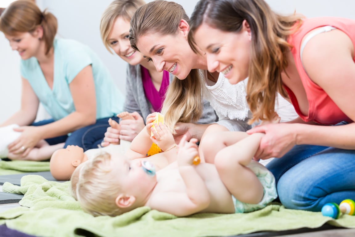 Group of Cheerful Women Learning to Take Care of Their Babies